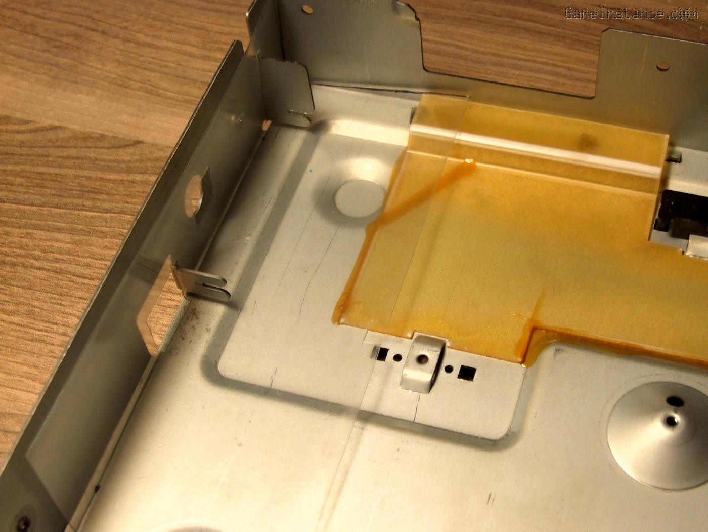 ST-S505 bottom case piece: punched-out PCB clamps creating a micro-SD card sized opening