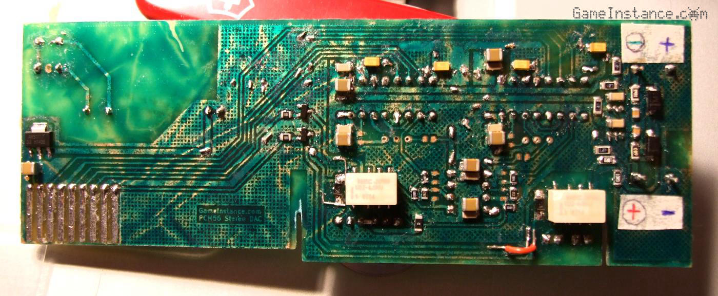 DIY-manufactured DAC board, SMD face; solder mask irregularities and few corrective hacks.